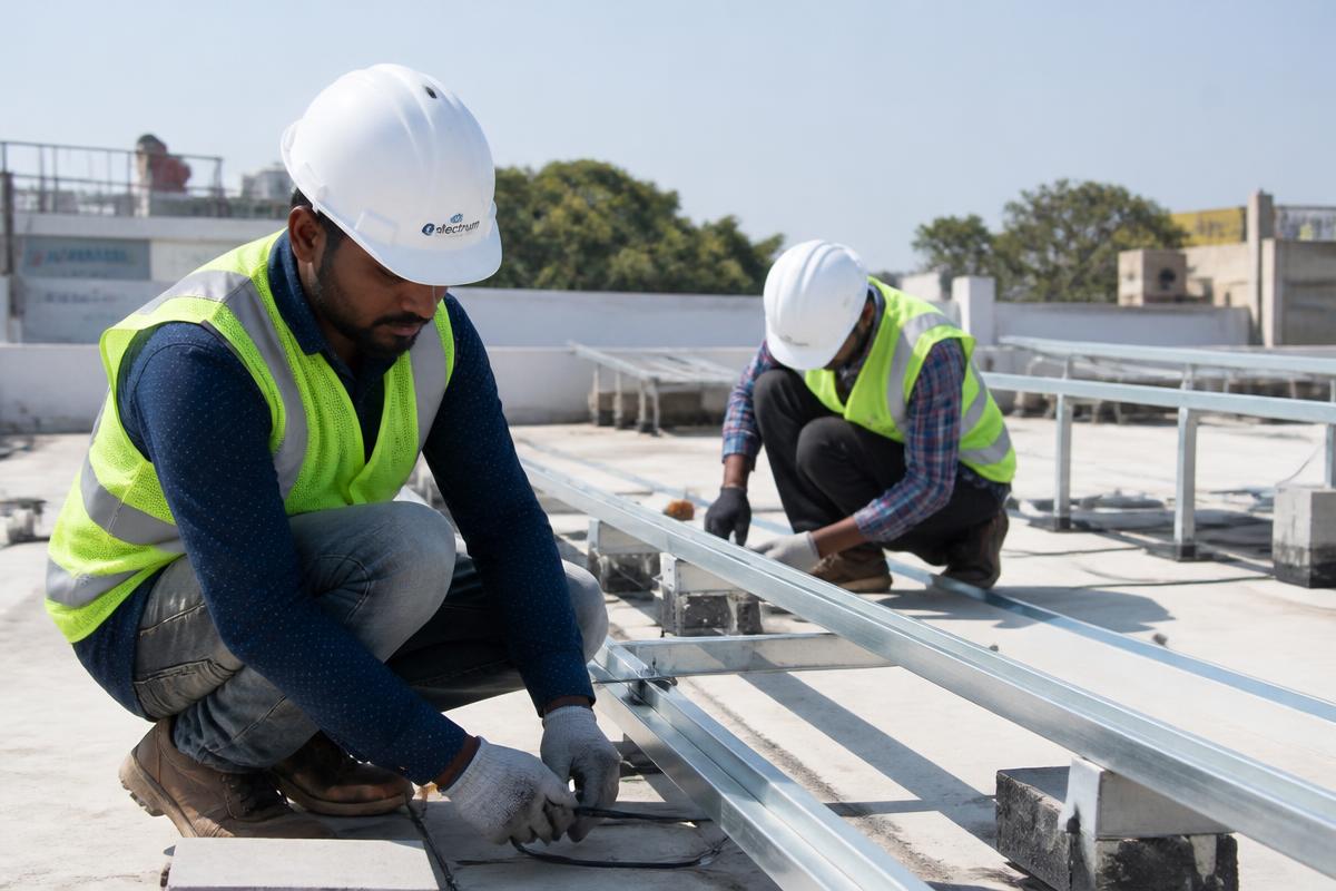 Solar engineers installing rooftop mounting structures