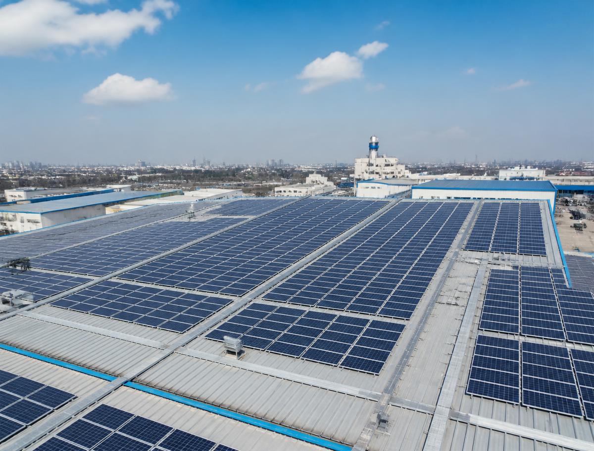 Large industrial factory rooftop solar array seen from the air